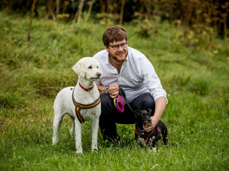 Freedom Project advocate Luke with two dogs