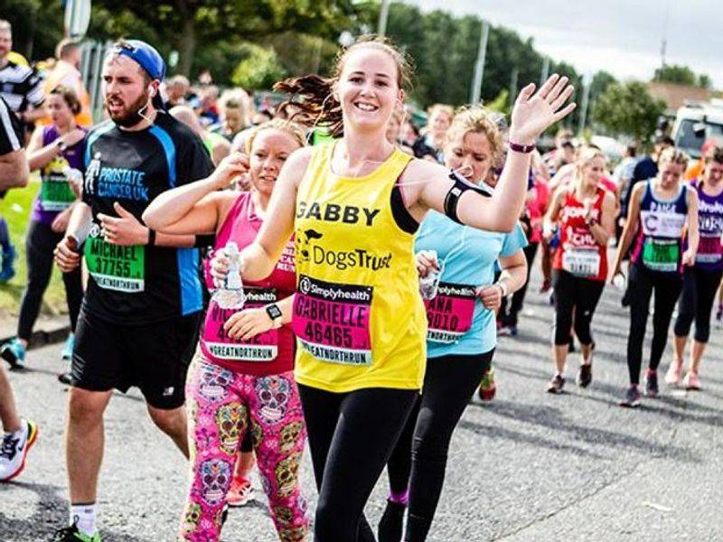 A fundraiser runs the Scottish Half Marathon wearing a Dogs Trust running top