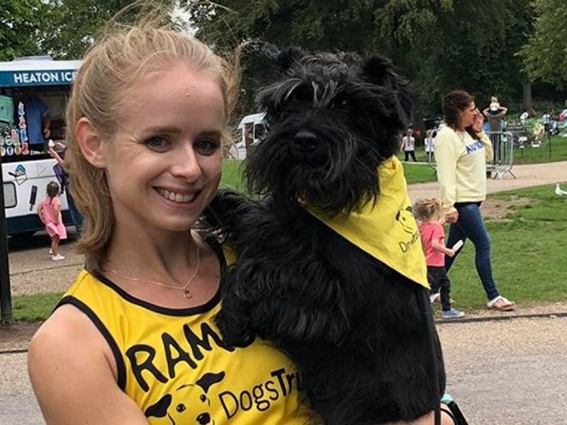 Dog Jog attendee poses with cute Scottish Highland Terrier