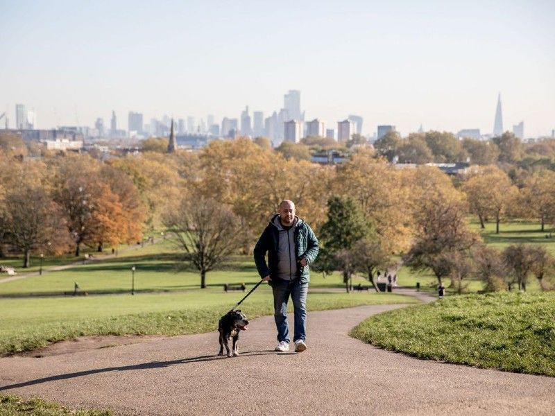 Hope project service user Paul walks his dog Blake in a park