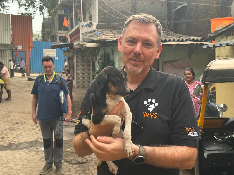 Dogs Trust CEO Owen Sharp holding a stray puppy in Mumbai