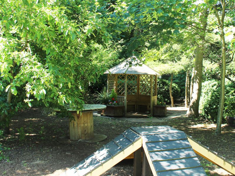 Merseyside Rehoming Centre exterior outside area with gazebo and play equipment.