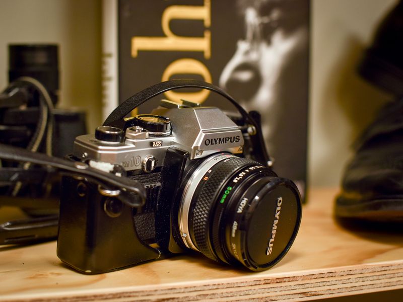 Newbury charity shop inside on a shelf is an Olympus camera.