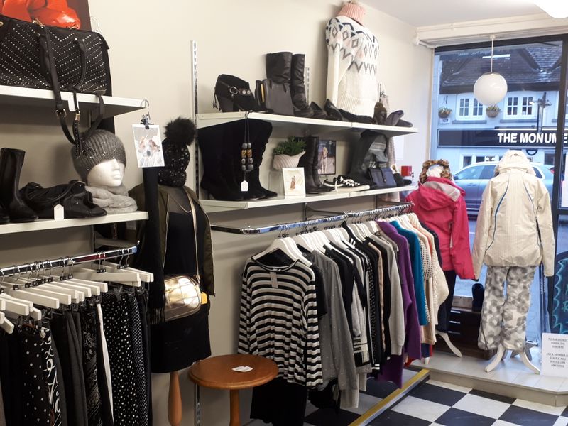 Newbury charity shop inside with racks of clothes and items for sale.
