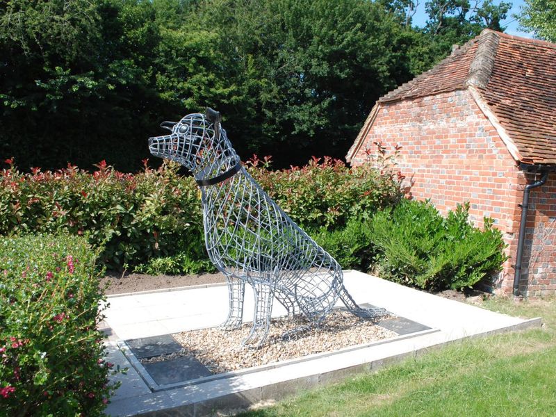 Newbury Rehoming Centre exterior at the memorial garden with a large wire dog sculpture.