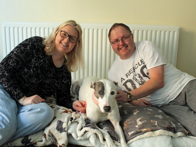 Johnathan and Alison sitting next to white and brindle Lurcher Dana 