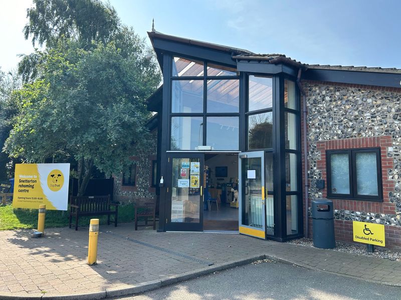 Outside Snetterton rehoming centre, with opening times dispay board and door open