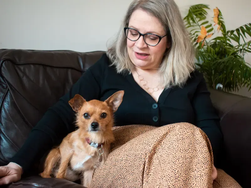 Foster carer Jo with dog on sofa