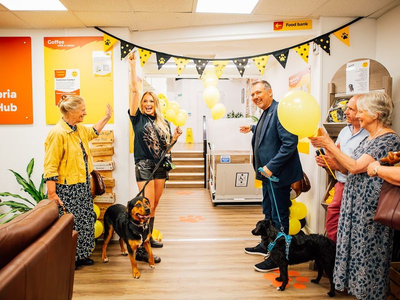Dogs Trust CEO Owen Sharp and guitarist Sophie Lloyd celebrate the opening of the community hub